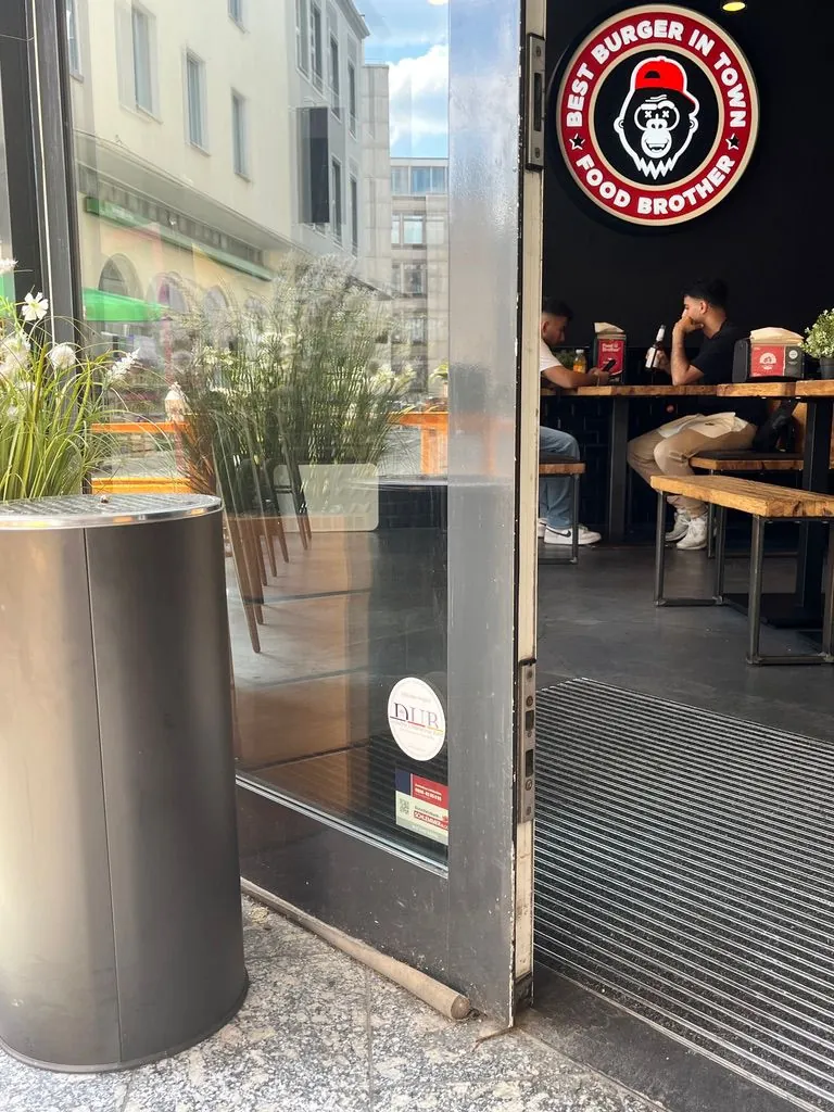 Entrance of a burger restaurant with a plaque on the door