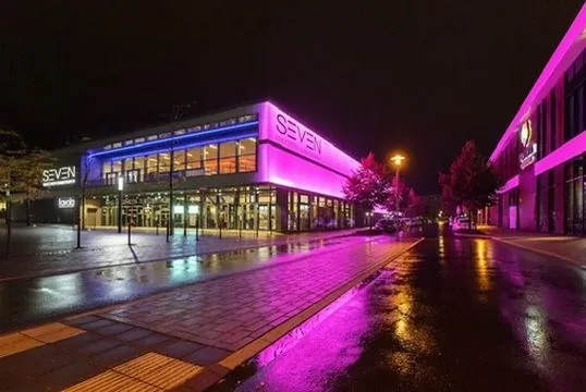 Cinema complex at night with violet lighting