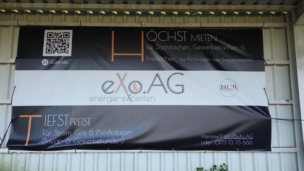eXo.AG energie-experten banner on the fence of a sports ground
